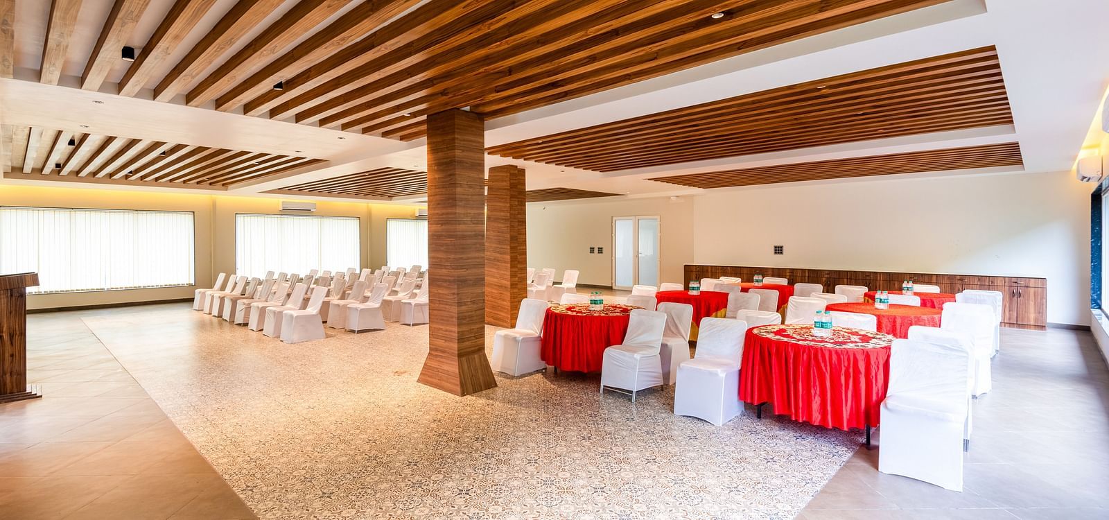 Banquet Hall at DLS Divine River Resort and Spa featuring  chairs table and a stage